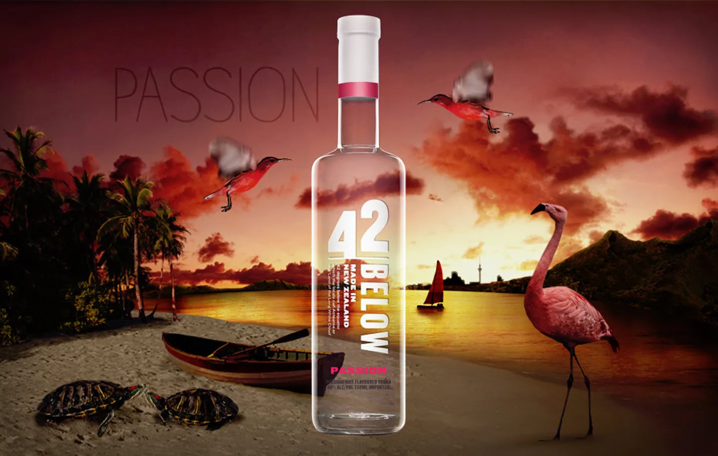 42Below Passion flavour world — bottle on a tropical beach at sunset with flamingos, scarlet birds, and a sailing boat